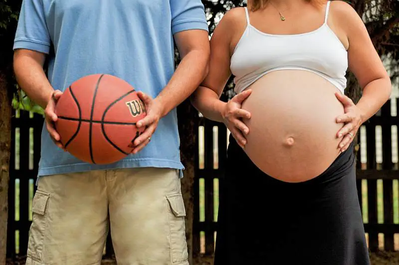 pregnant woman and man with basketball